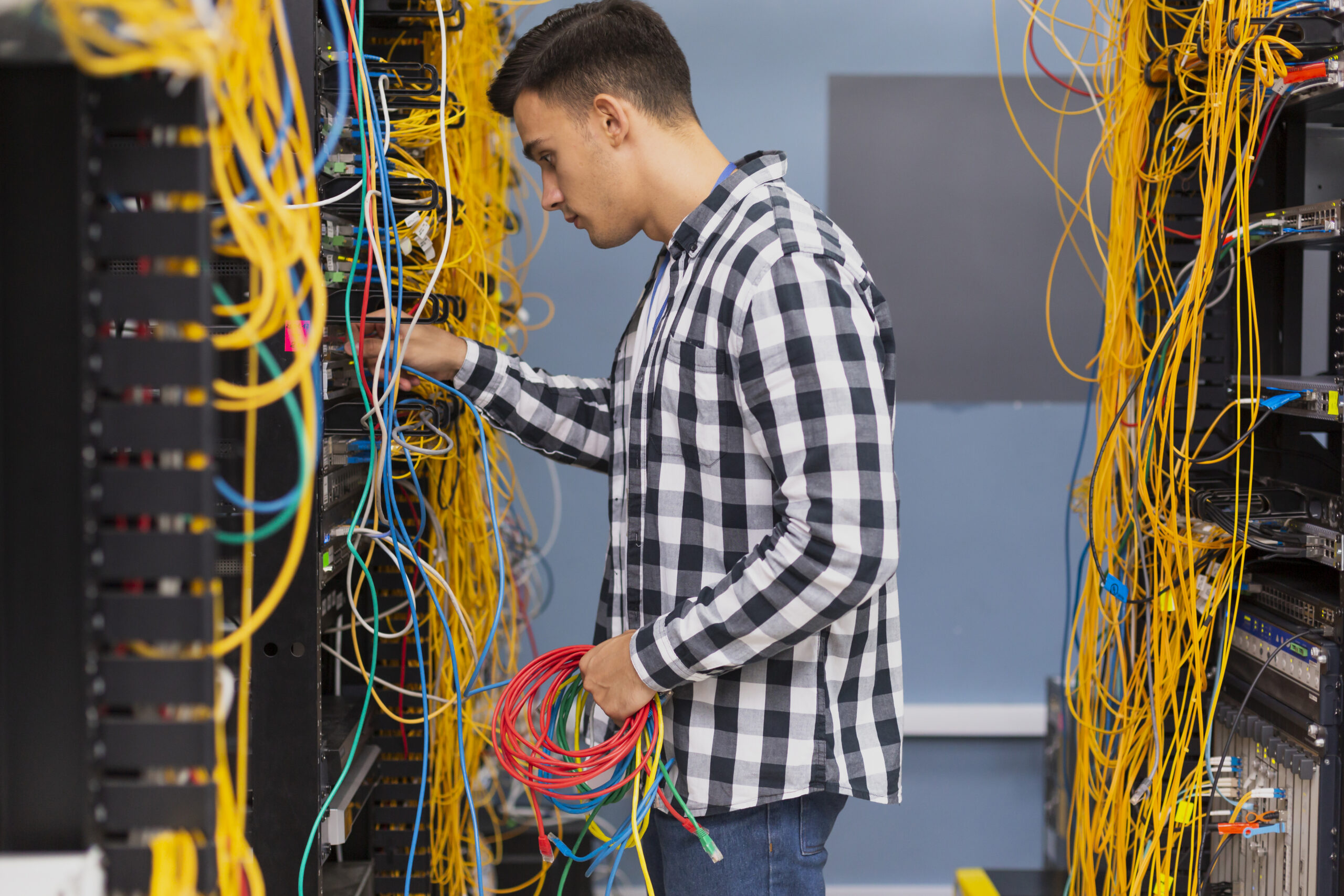 young-network-engineer-with-ethernet-wires-medium-shot young-network-engineer-with-ethernet-wires-medium-shot